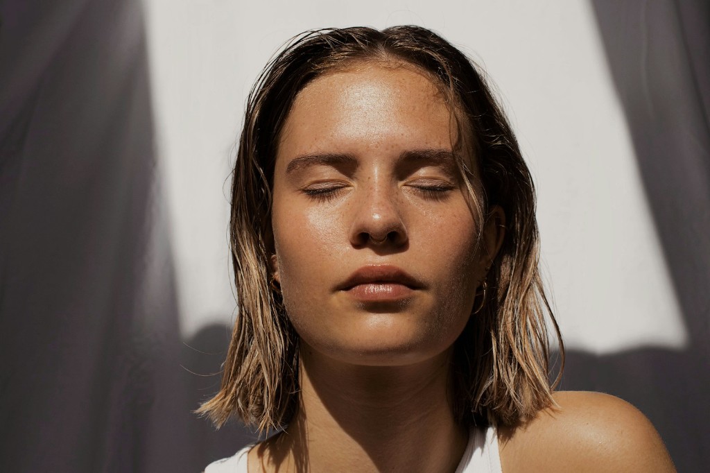 Woman with closed eyes in soft, calming light
